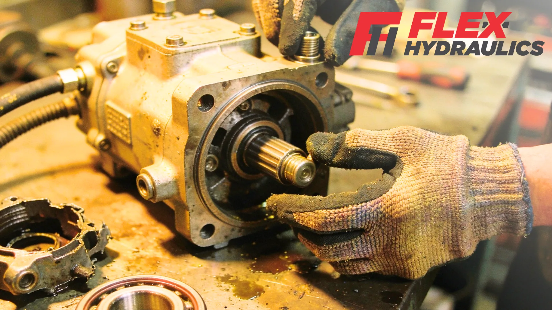 PTO pump problems being fixed by a hydraulic specialist on a workbench.